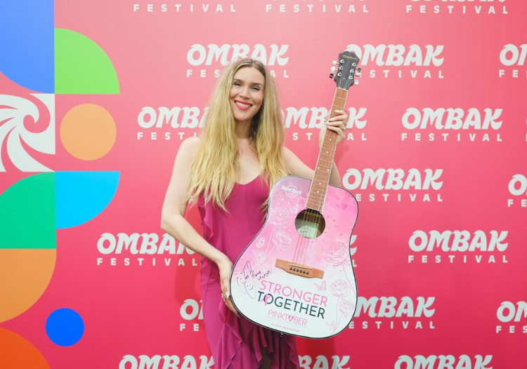 a woman holding a guitar
