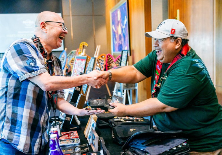 two men shaking hands in a room