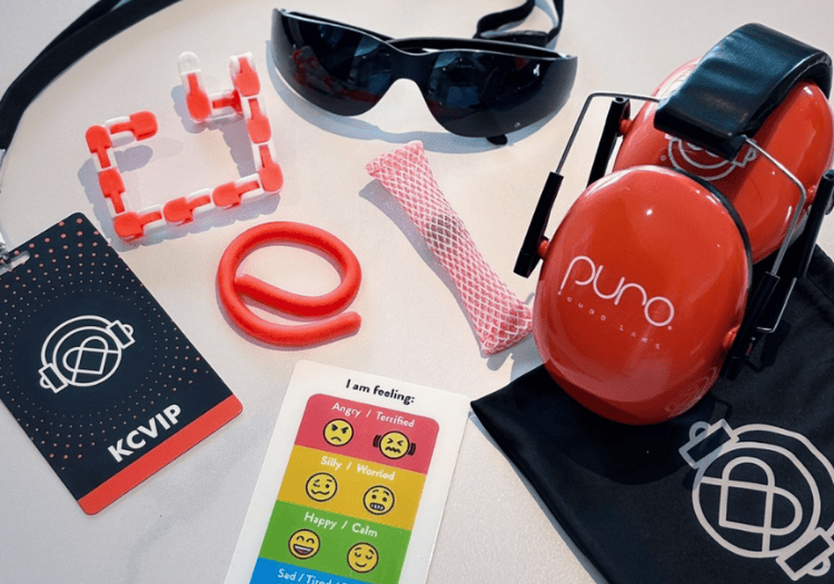 a red headphones and sunglasses on a white surface