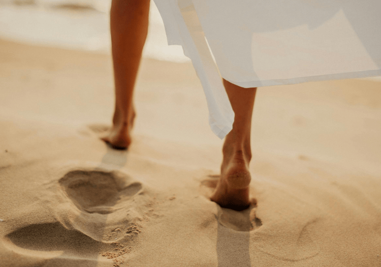 a person walking on sand