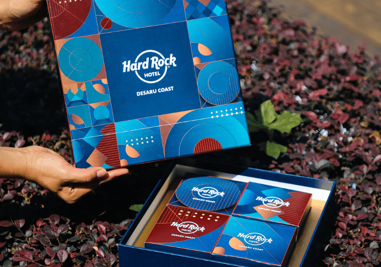 a hand holding a box with a blue and red box