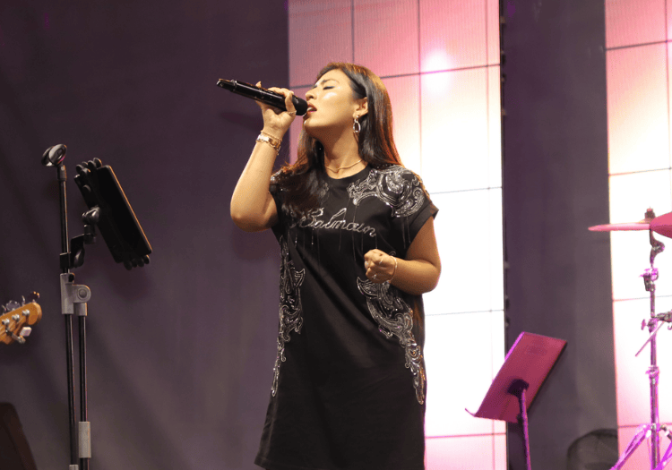 a woman singing into a microphone
