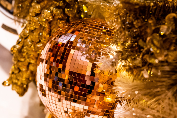 a gold disco ball on a tree